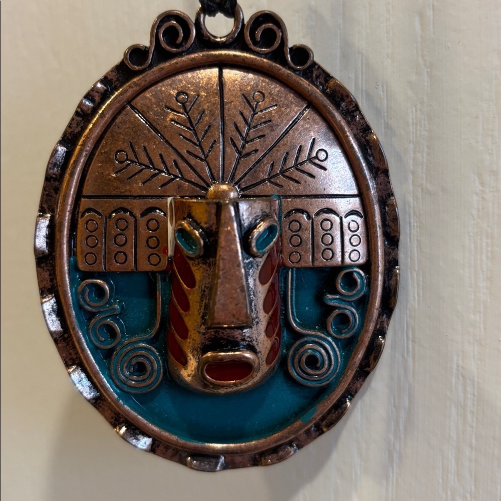 BRONZE FACE MEDALLION W/ TEAL BLUE AND RED ENAMEL ACCENTS BLACK ADJUSTABLE CORD